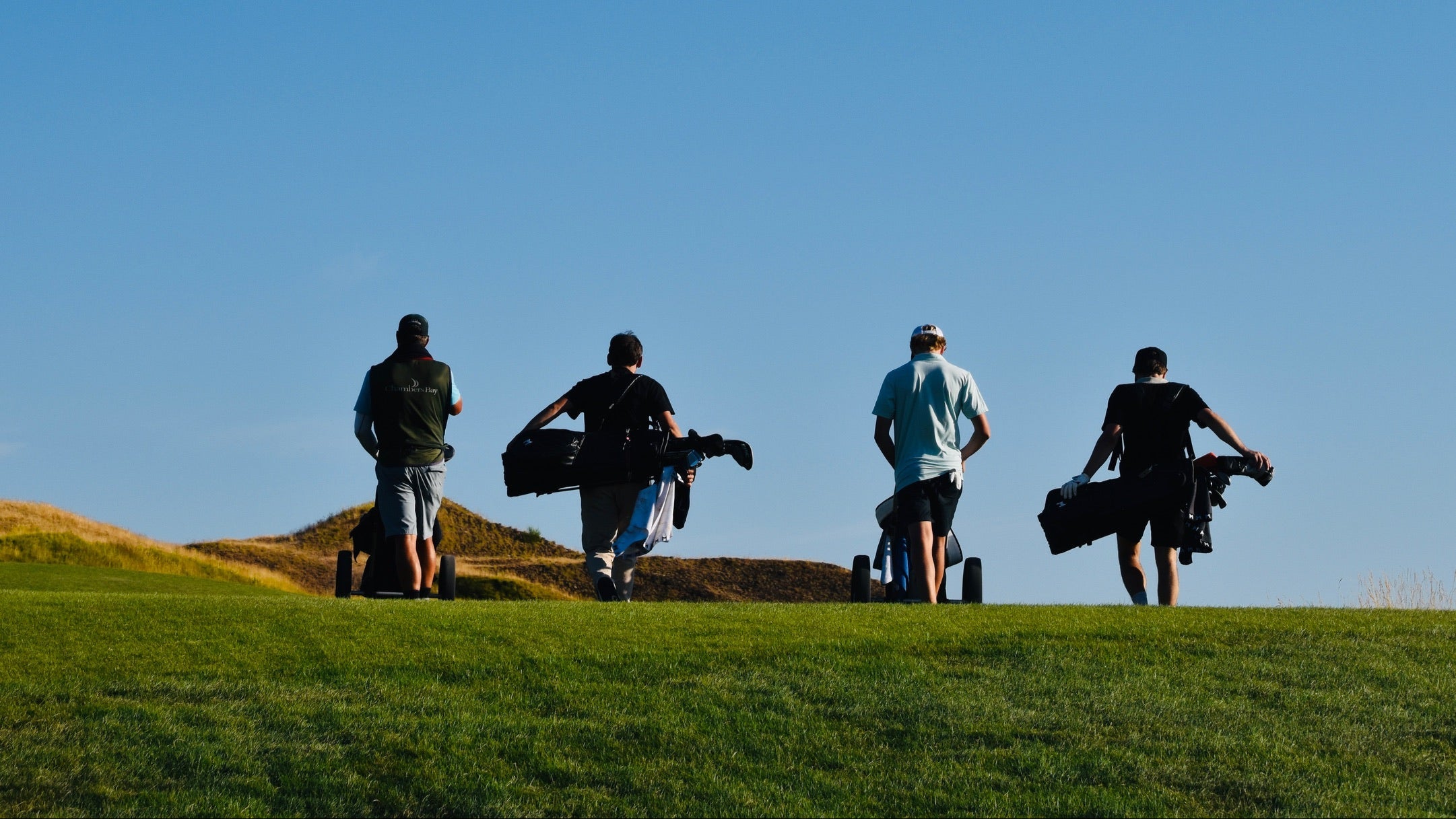 Group golf photo of team walking the Chambers Bay golf course.