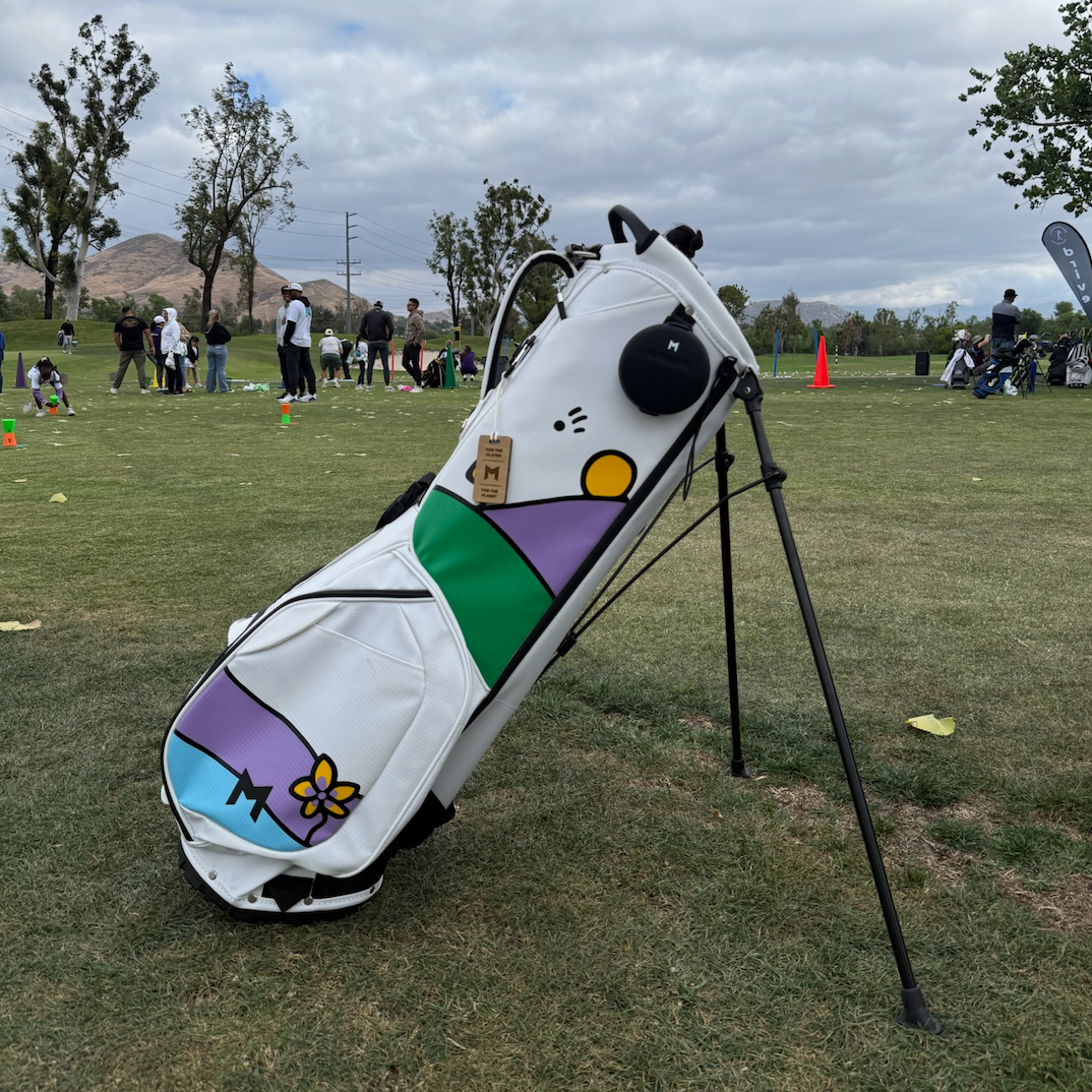 Custom White Golf bag with colorful designs hand painted on a golf course
