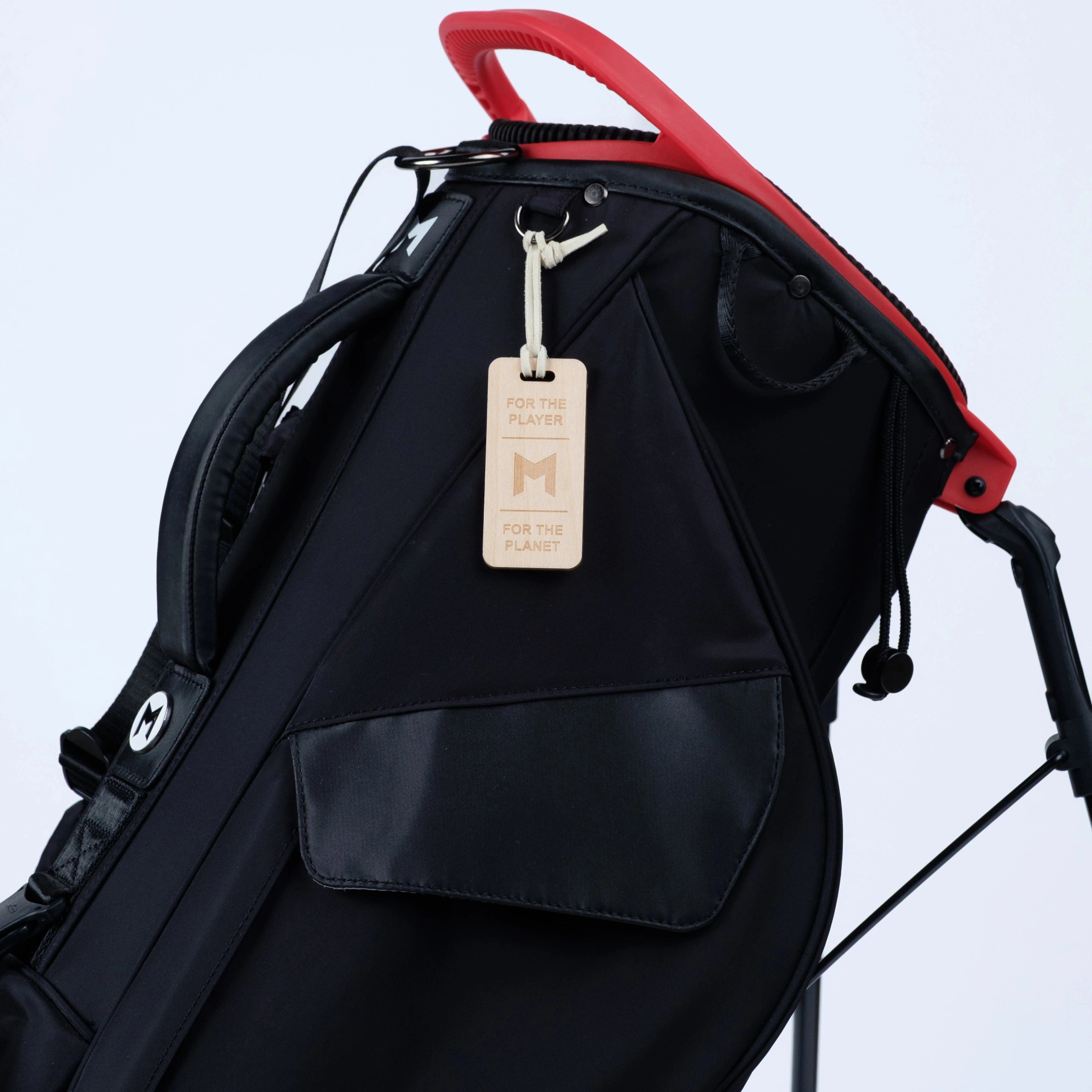 Black golf bag with magnetic full length storage pocket