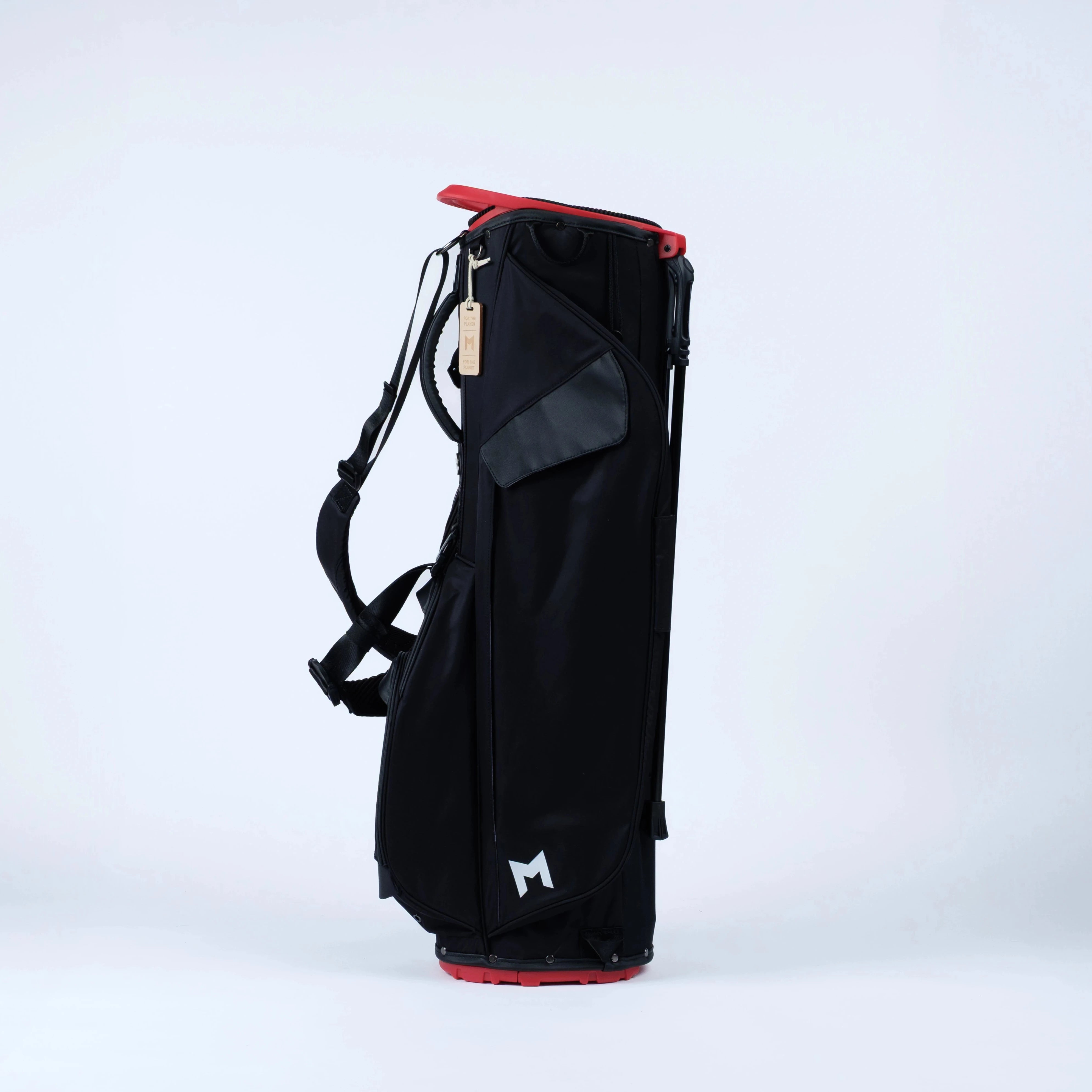 Black golf bag on stand with straps and magnetic pockets