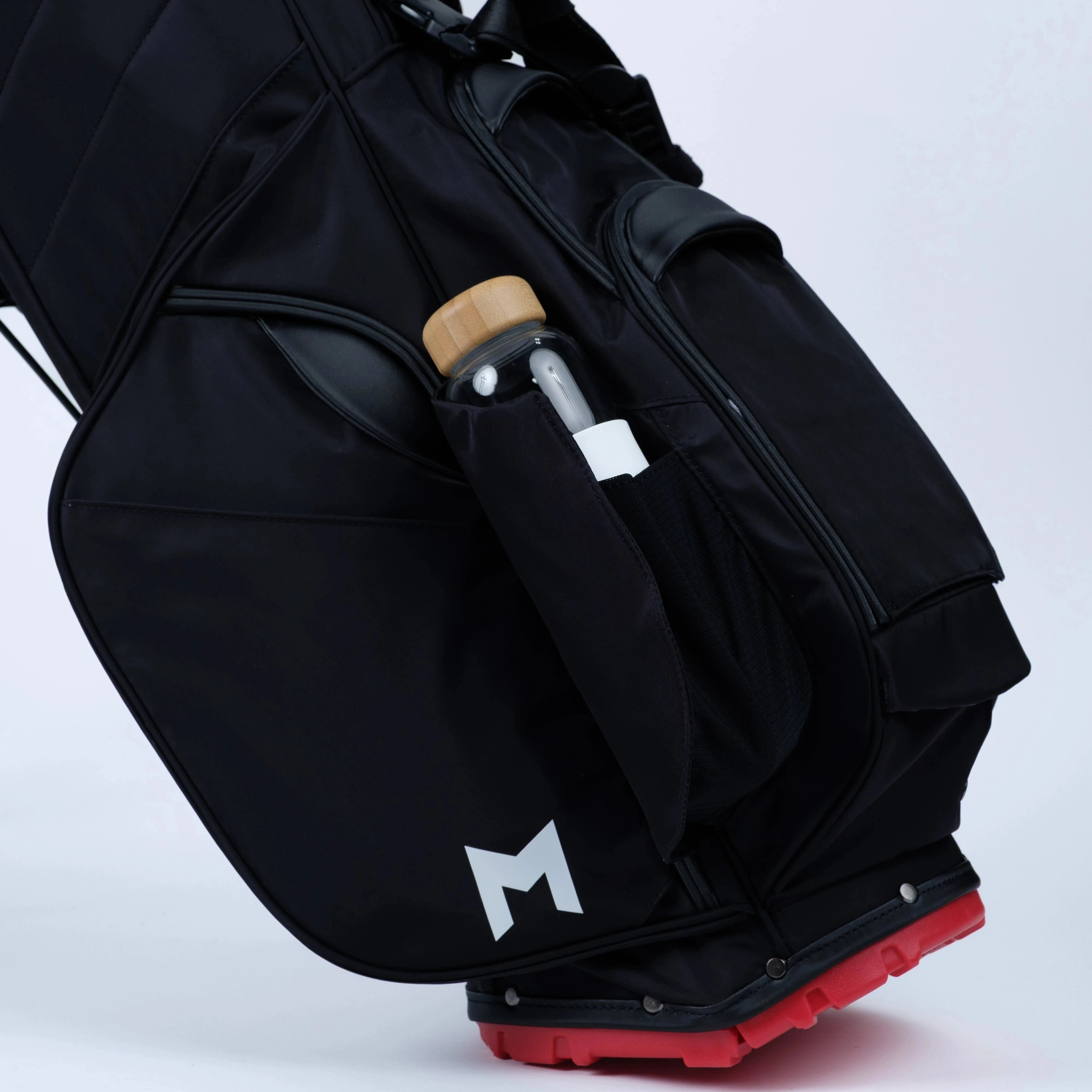 Black golf bag with a tour golfer water bottle pocket on a white background