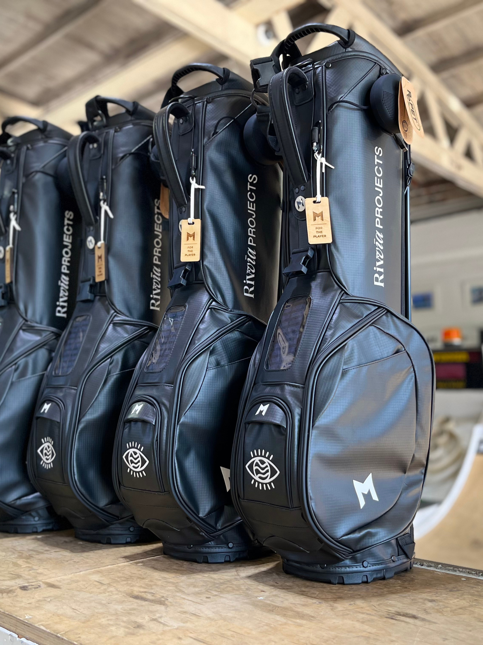 MNML GOLF custom hand painted black MR1 sustainable golf bag fleet with Julian Wilson's Rivvia Projects logo.