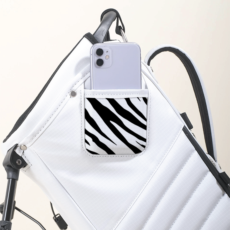 MNML GOLF collaborated with artist, Axel Lony, to hand paint a zebra print on a bright white MR1 recycled golf bag.