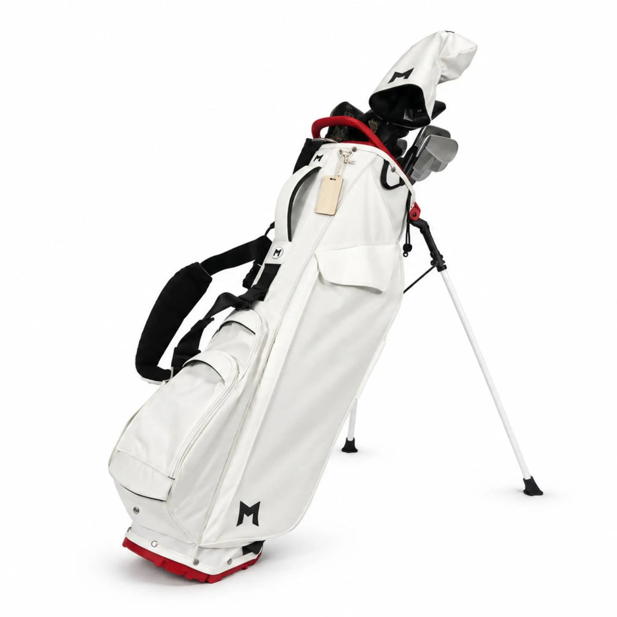 A white stand golf bag with black and red accents, standing on a white studio background. The bag is shown with several golf clubs inserted, featuring a white shoulder strap, a stand leg, and a small black logo on the front pocket.
