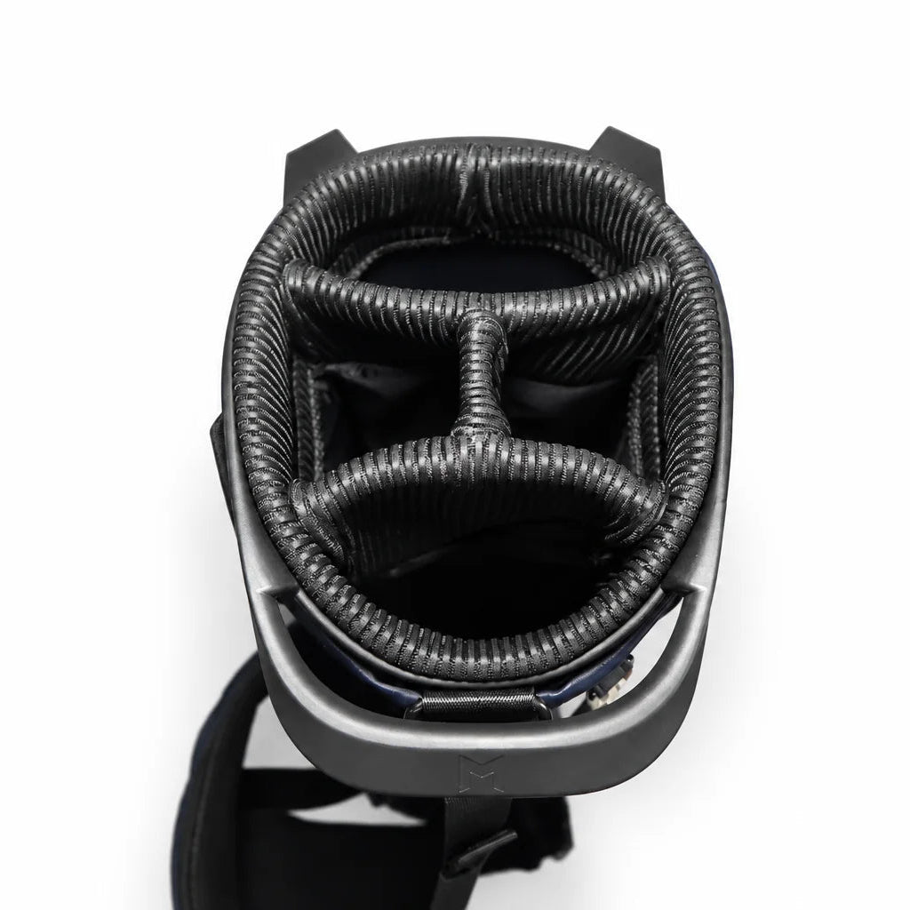 Top-down view of a black golf bag showing its divider system and storage compartments lined with textured black material, set against a plain white background.