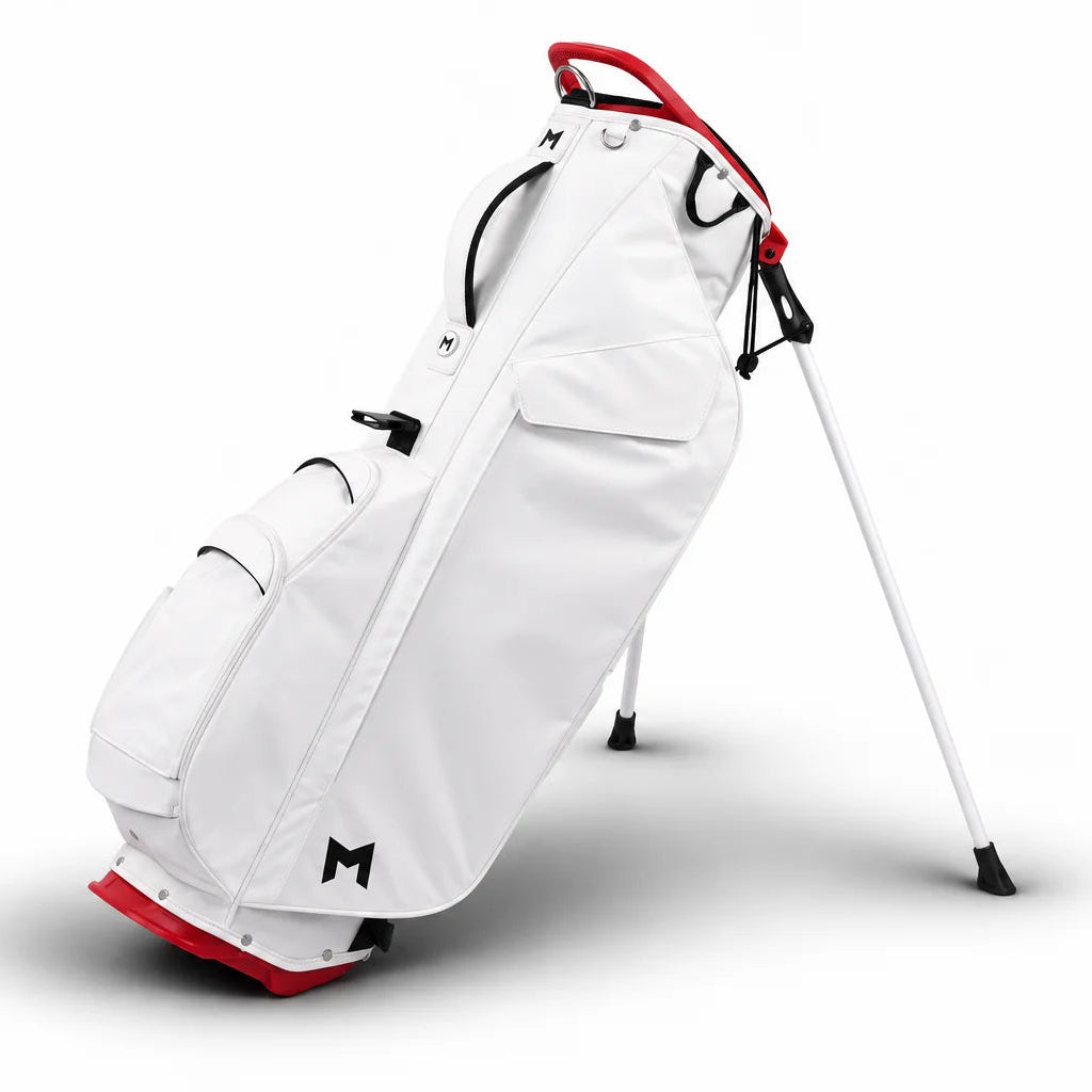 A white golf stand bag with red accents and black details, standing on its legs against a clean white background.