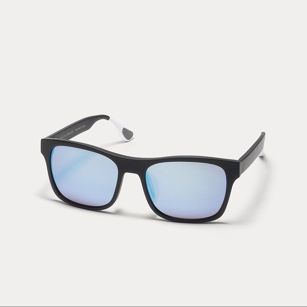 Black square sunglasses with mirrored blue lenses, shown at a three-quarter angle on a light gray background.