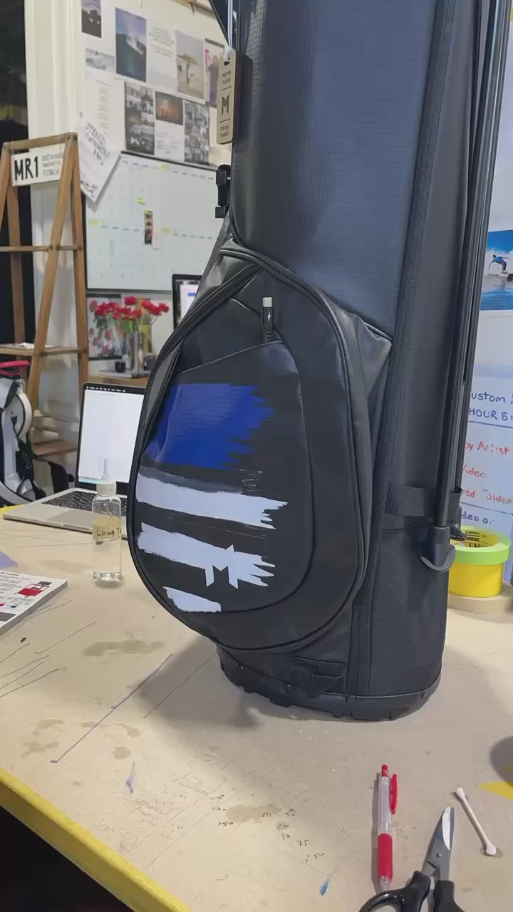 Timelapse of professional artist hand painting custom black golf bag with USA flag