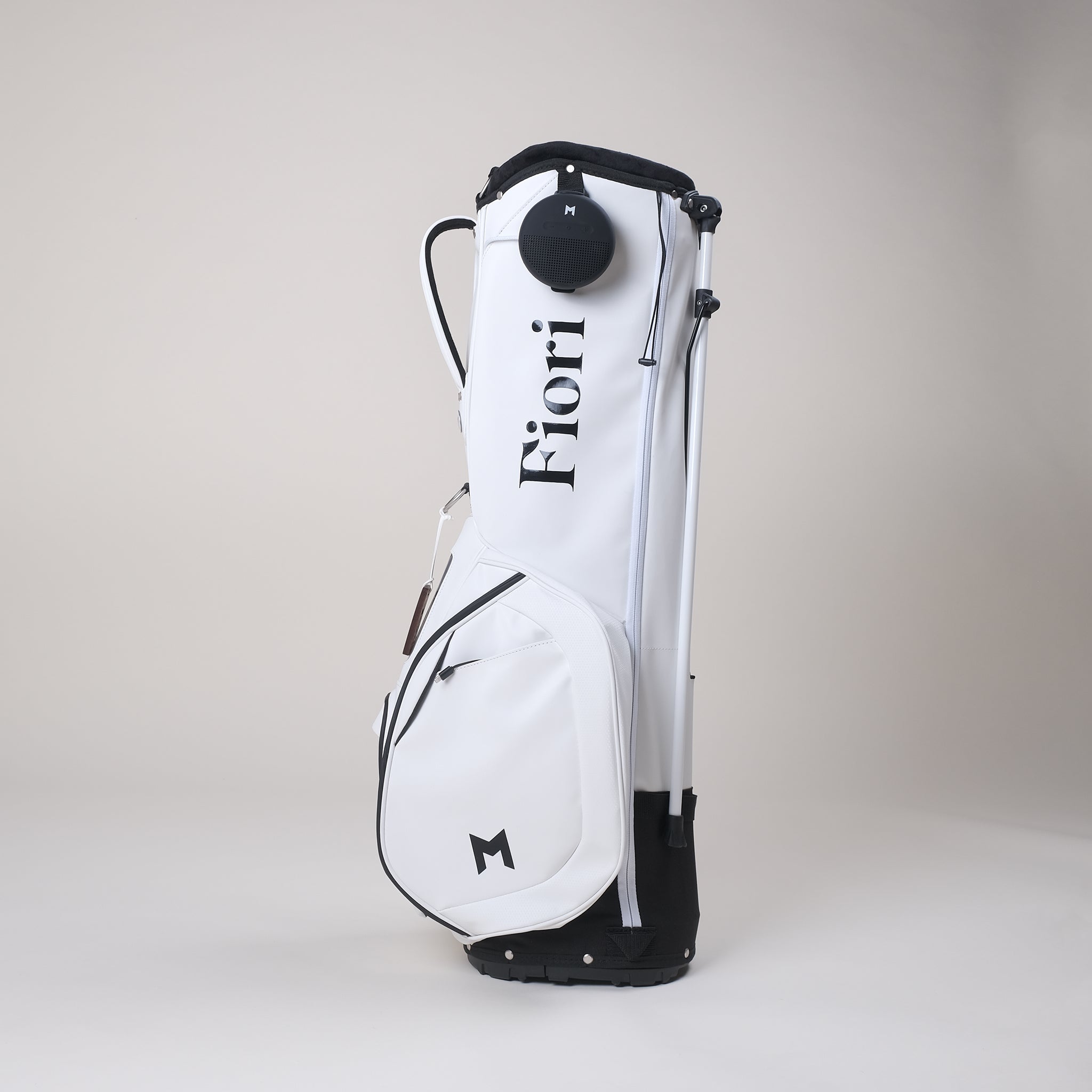 The MNML GOLF and Fiori Golf collaboration features a white MV2 golf bag with a contrasting black Fiori Golf logo.