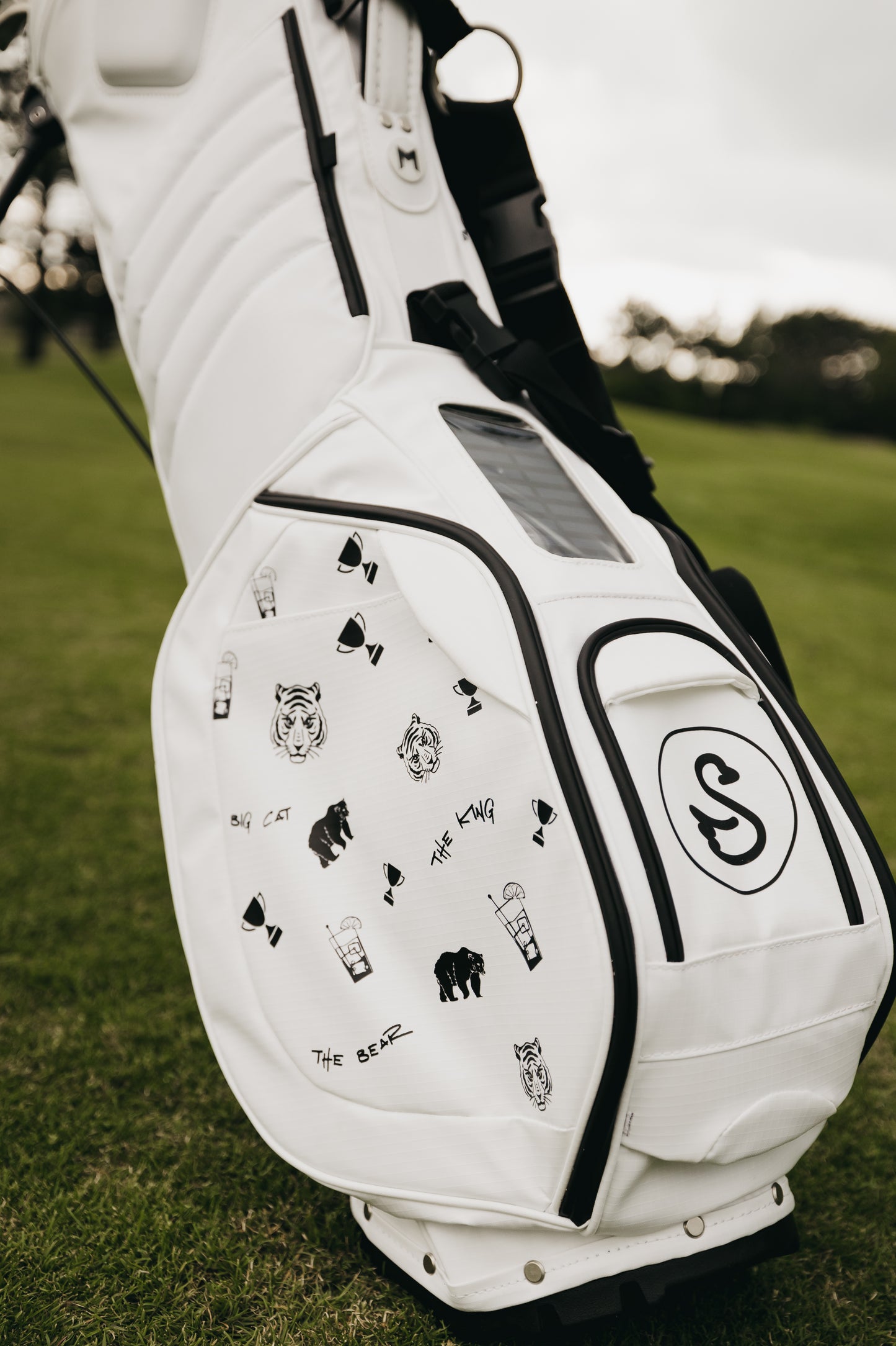 White MNML GOLF bag with Swannies collaboration print hand painted on magnetic thermal pocket.