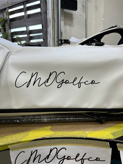 This is an image of our white MR1 sustainable golf bag with CMD Golf's company logo on the side panel.