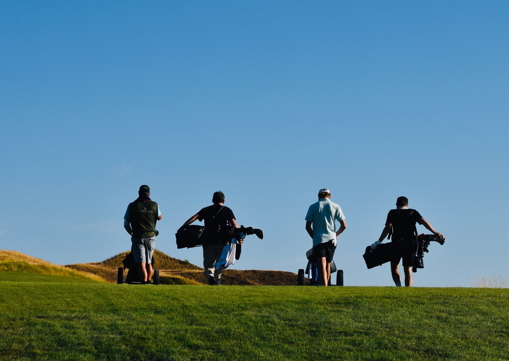 Group golf photo of team walking the Chambers Bay golf course.