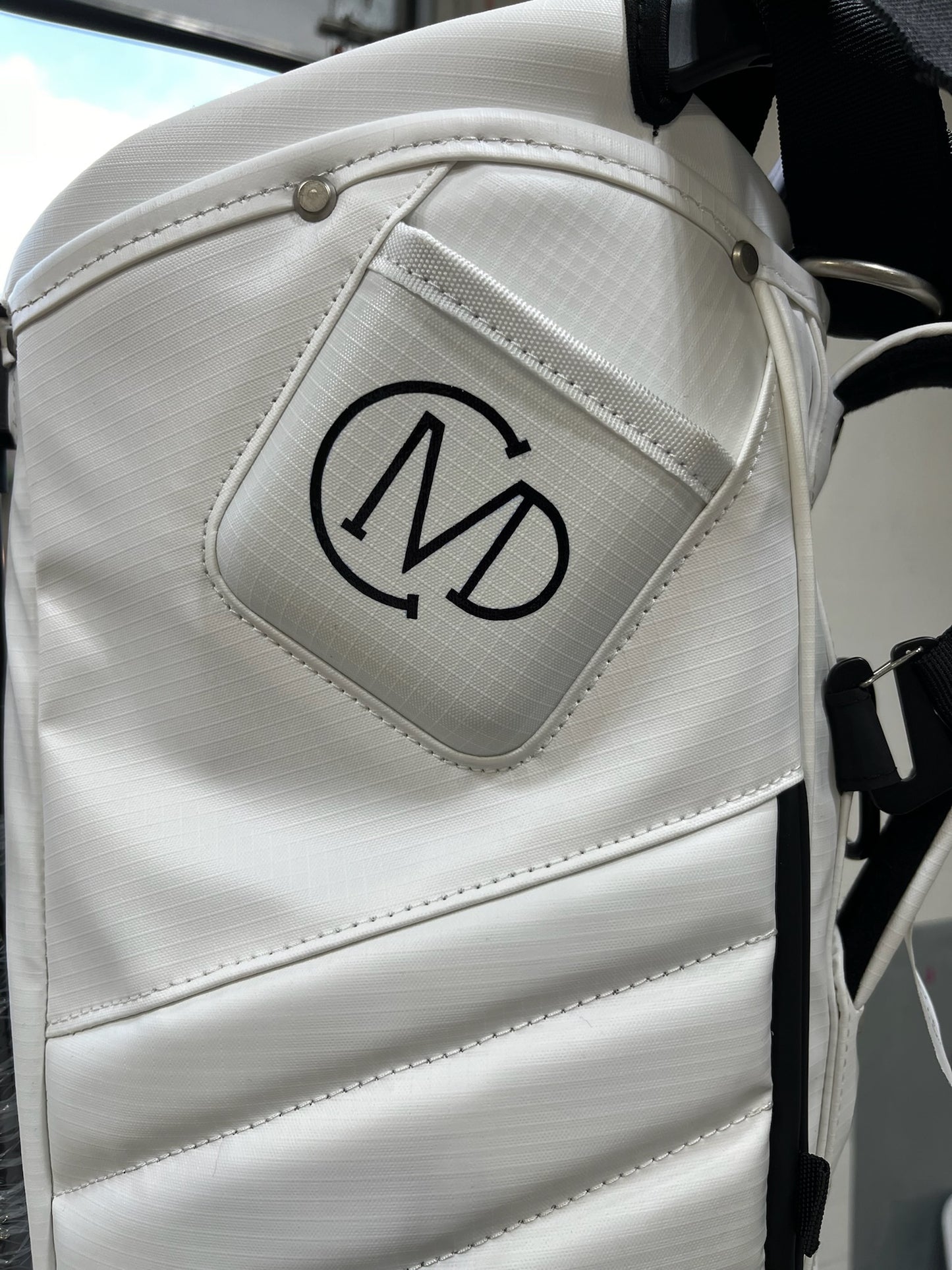 CMD Golf's logo hand painted on the phone filming pocket of our white MR1 eco golf bag.