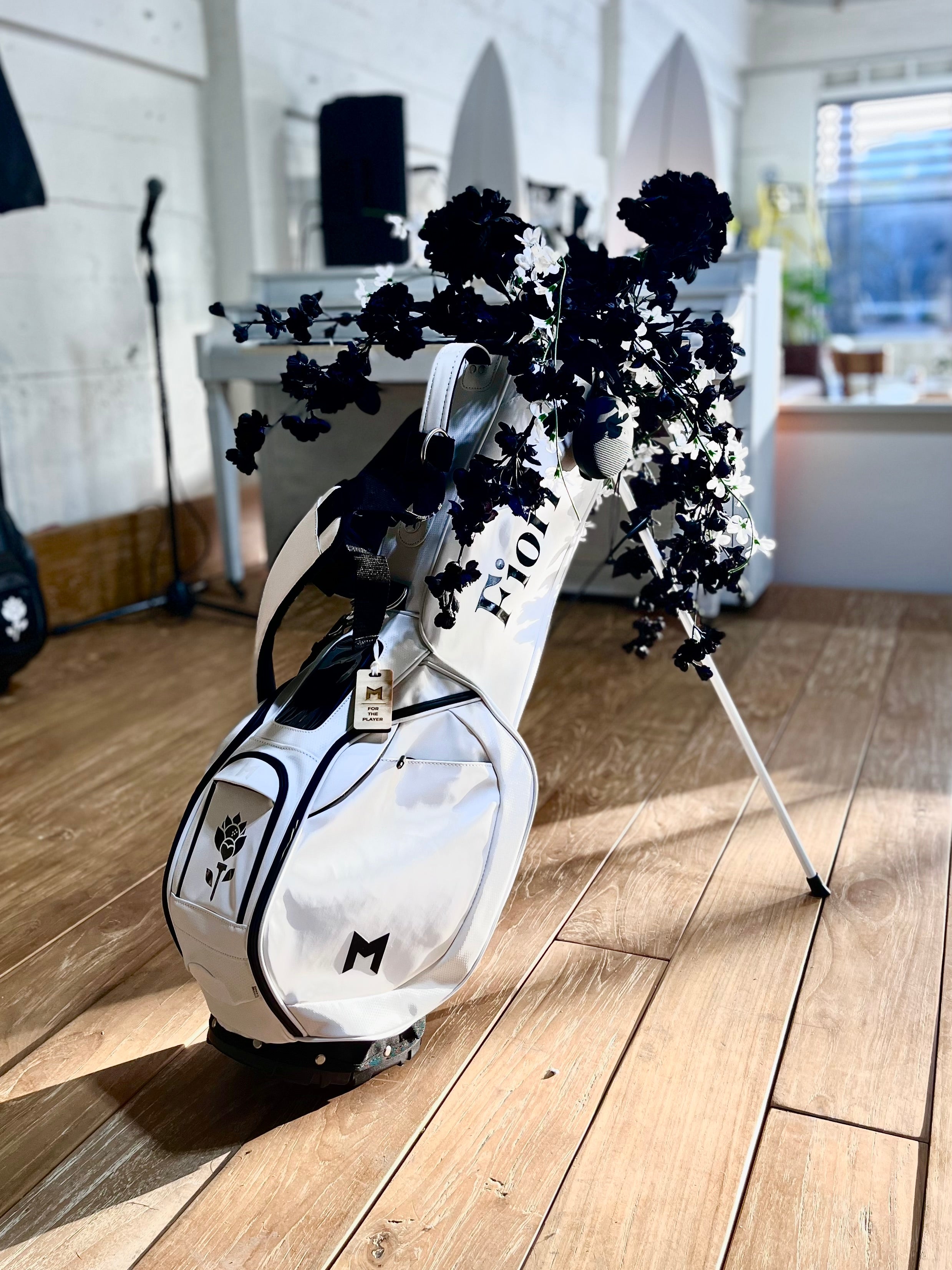 MNML GOLF bag with Fiori logo painted on side panel and ball pocket.