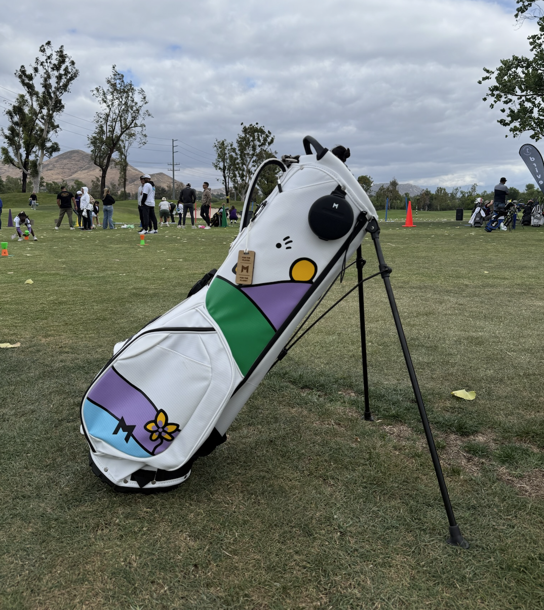 Custom White Golf bag with colorful designs hand painted on a golf course