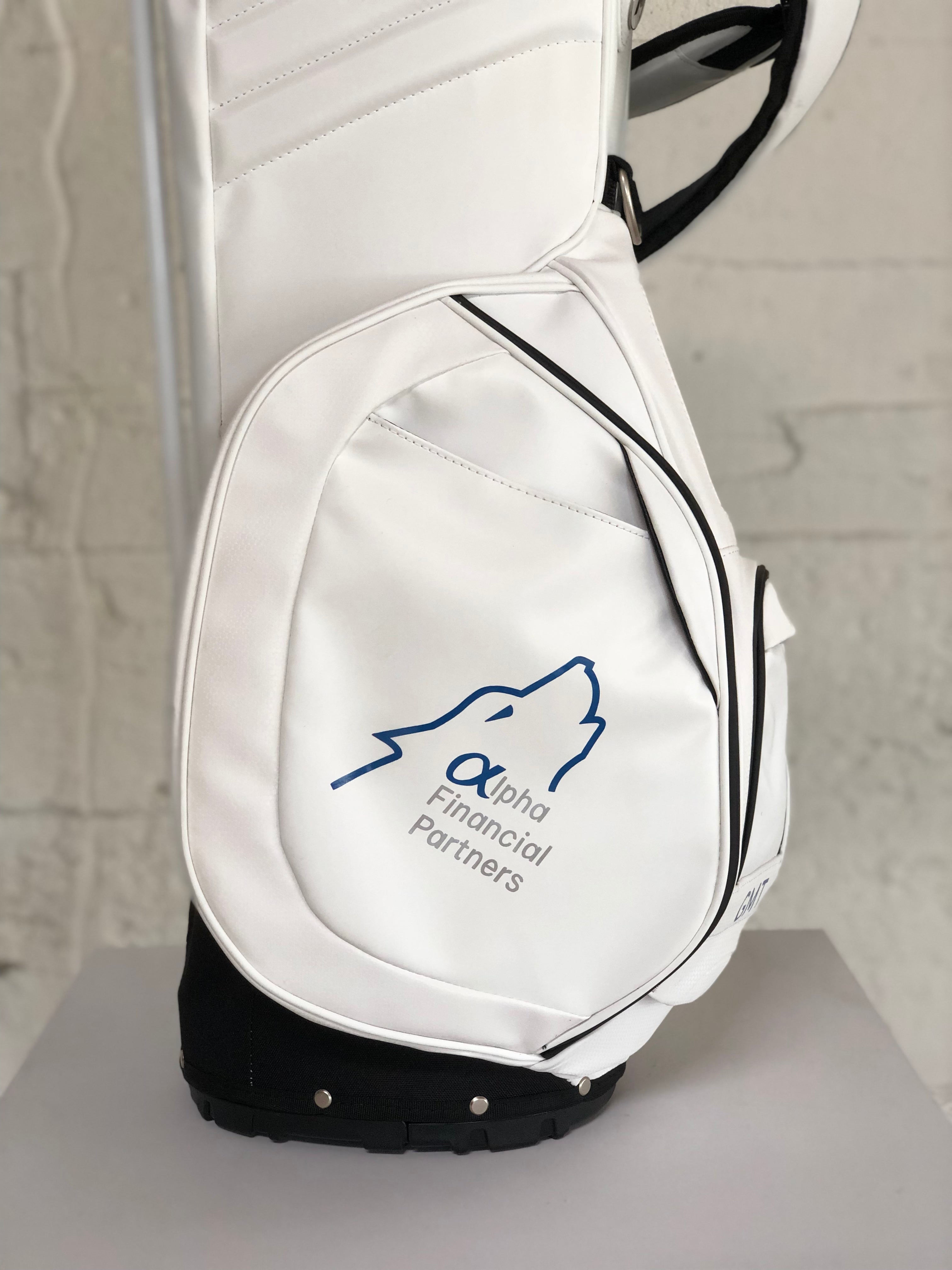 MNML GOLF white bag with financial company logo painted on thermal cooler pocket.