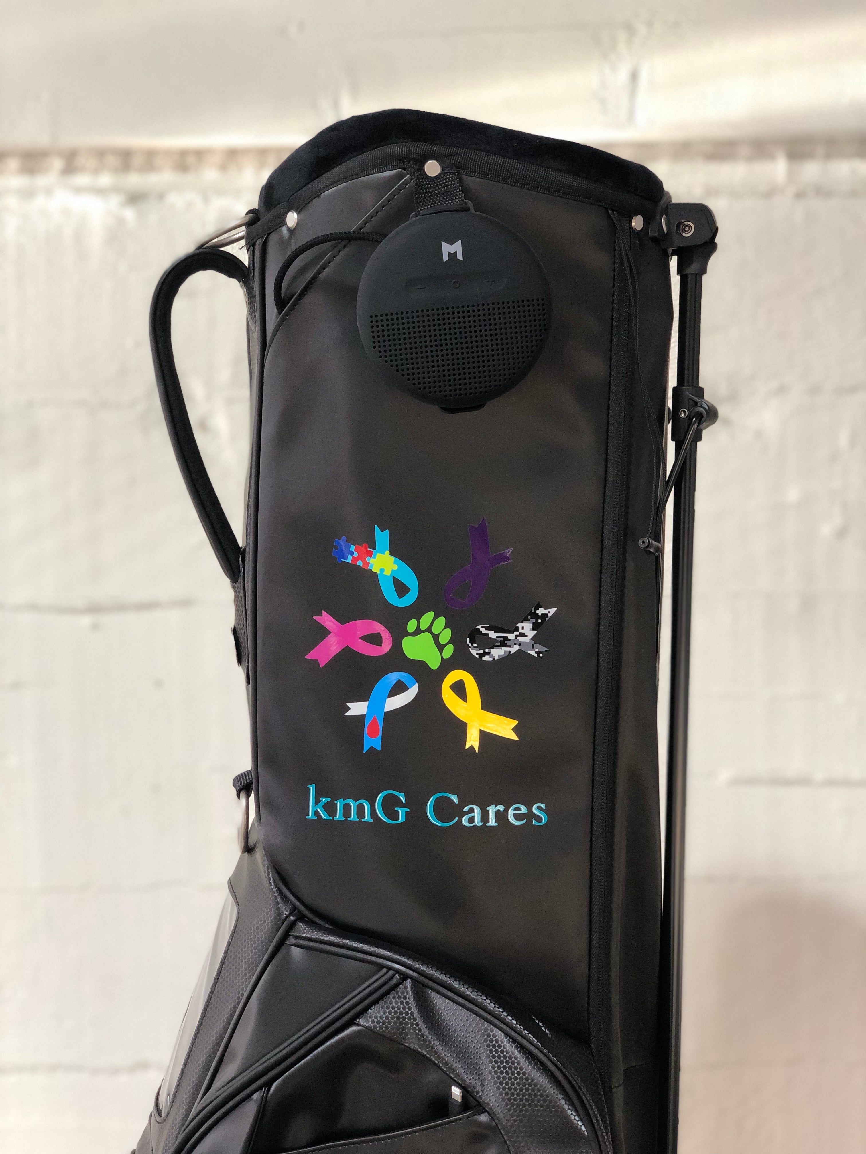 MNML GOLF black golf bag with KMG company logo painted on side panel.
