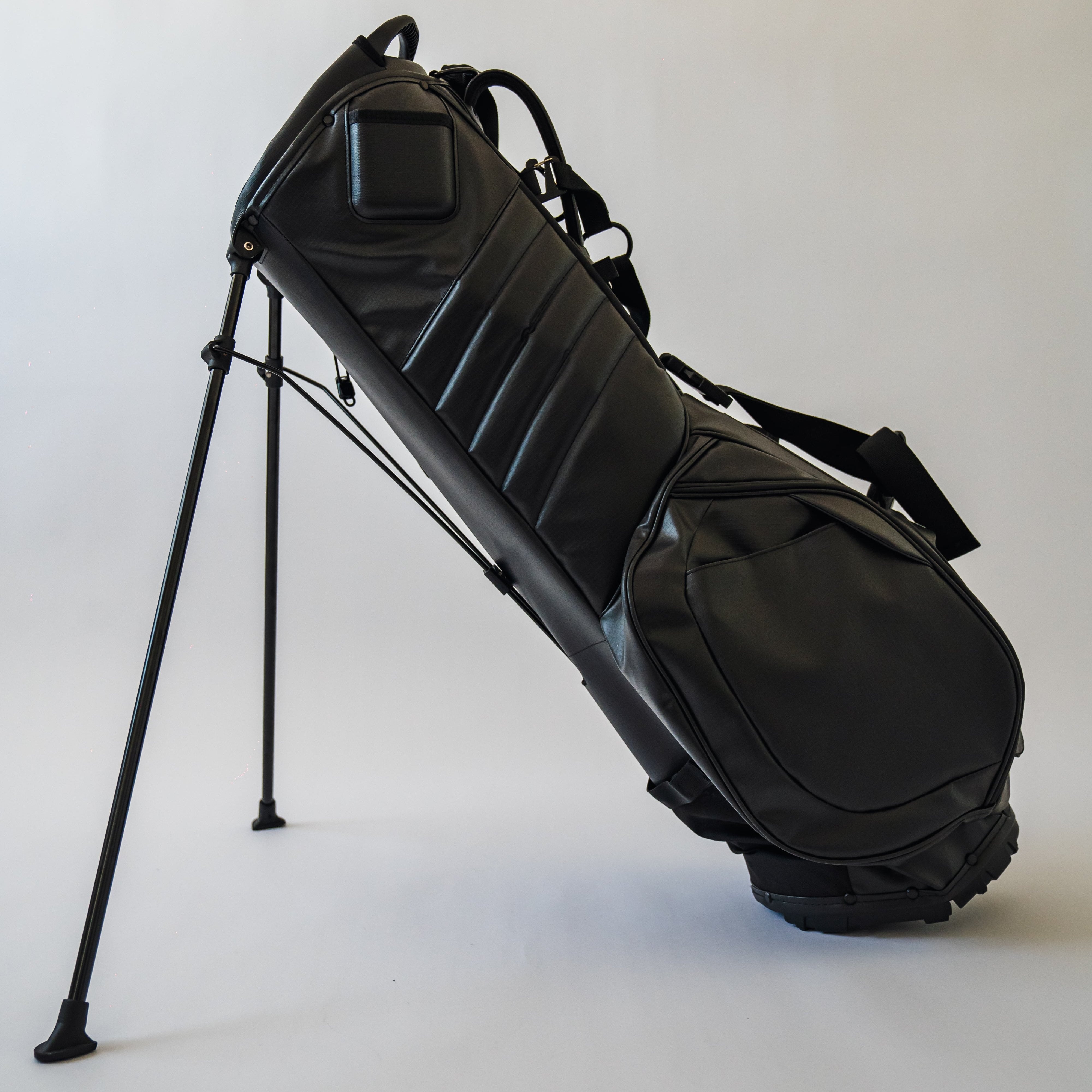 Left side of black MR1 custom golf bag, featuring the phone filming pocket and magnetic thermal pocket.