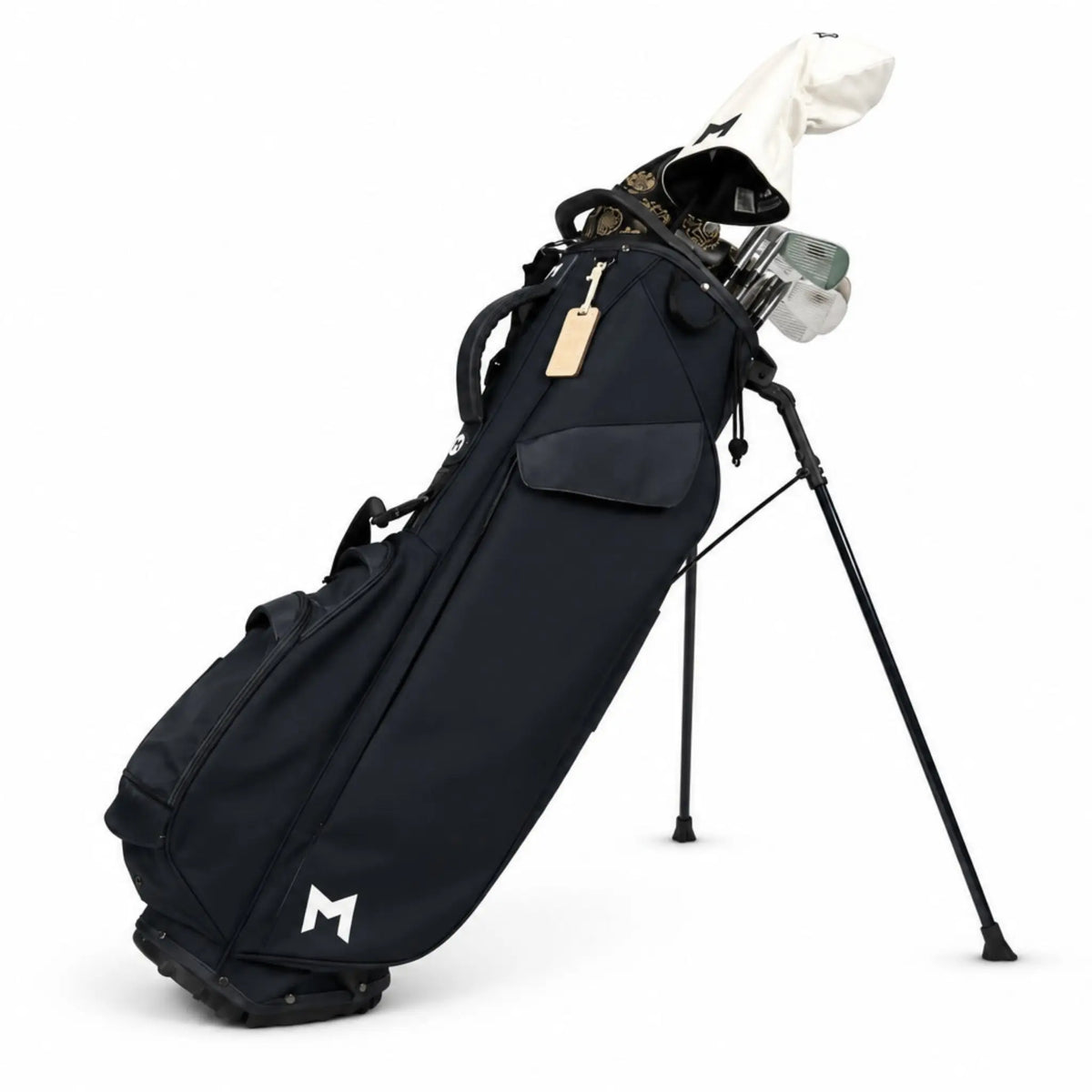 A black stand golf bag with a white stylized 'M' logo near the bottom, holding golf clubs on a white background.