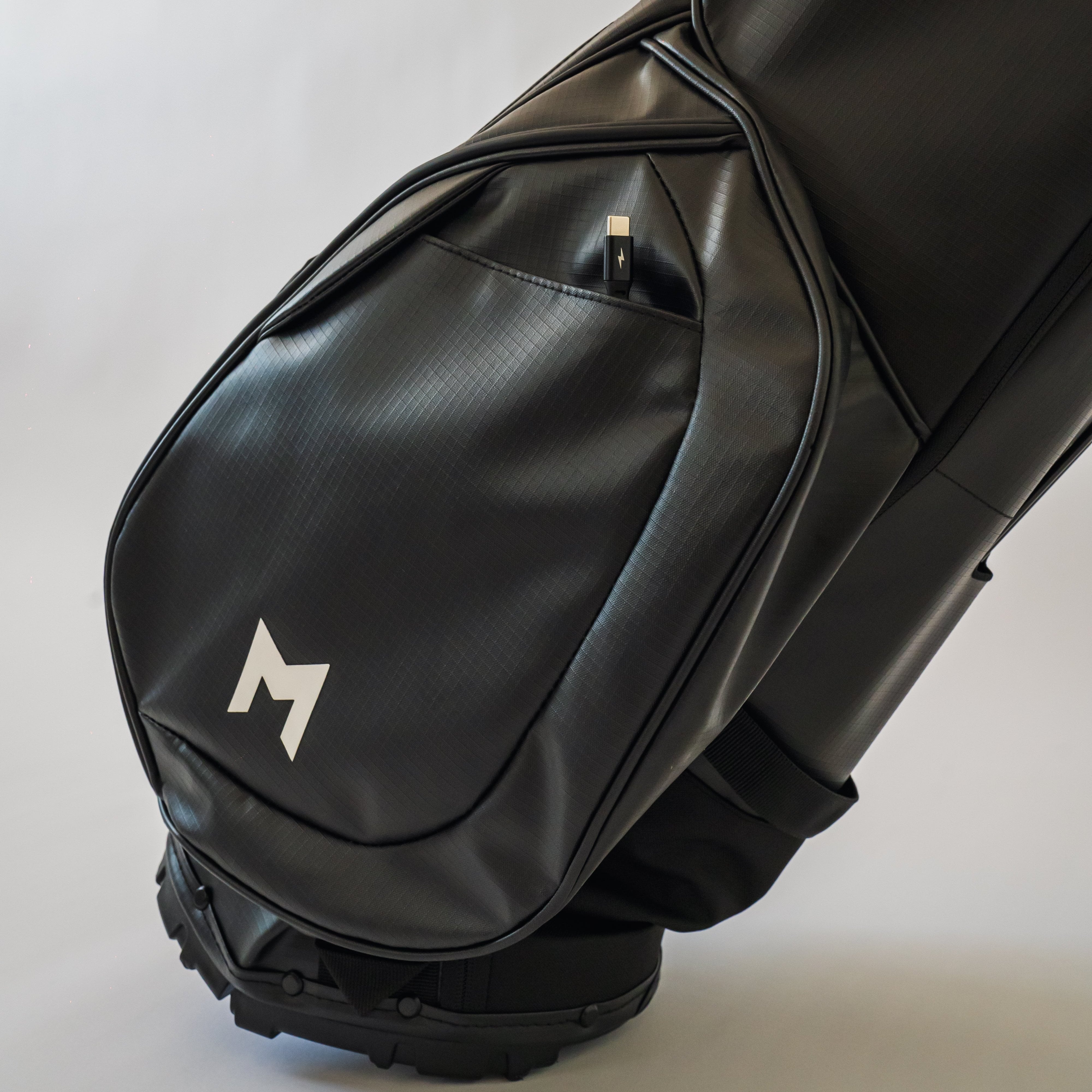 MNML GOLF's black MR1 customizable golf bag's internal phone charging cable.