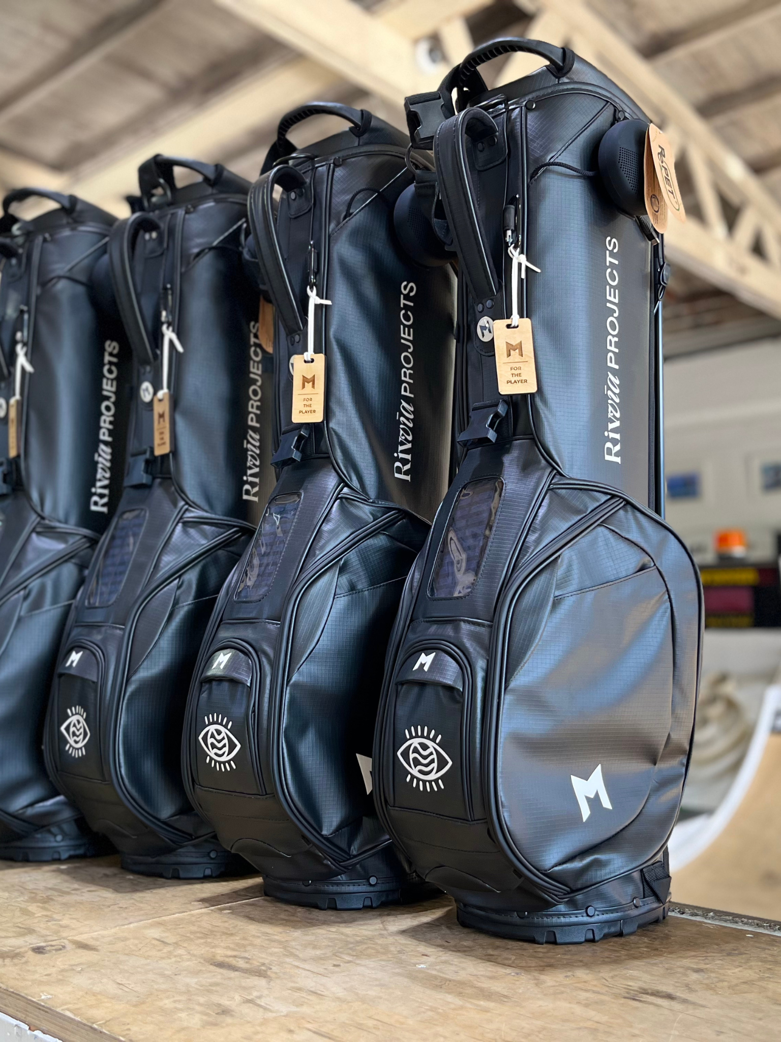 MNML GOLF custom hand painted black MR1 sustainable golf bag fleet with Julian Wilson's Rivvia Projects logo. 