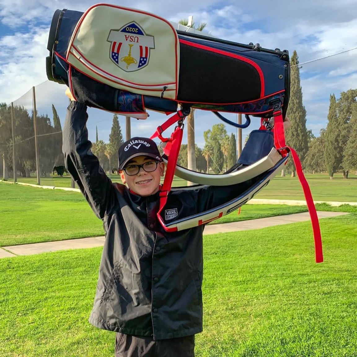 A junior golfer with a golf bag donated by MNML GOLF and the SCGA.