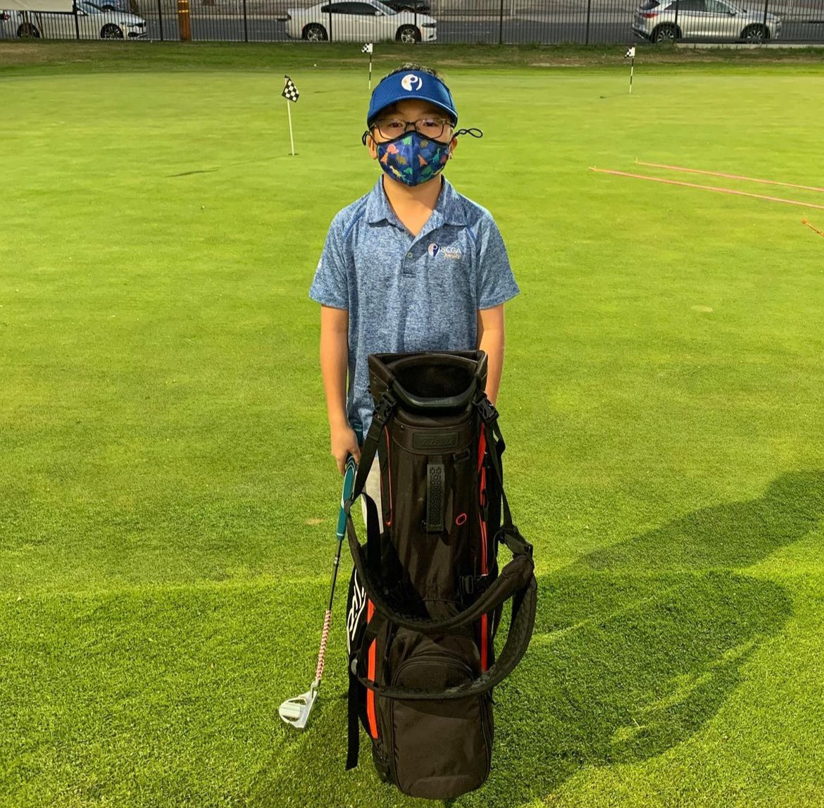 Little junior golfer with a new bag from MNML GOLF and the SCGA's trade it forward program.