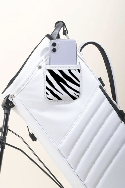 MNML GOLF collaborated with artist, Axel Lony, to hand paint a zebra print on a bright white MR1 recycled golf bag.