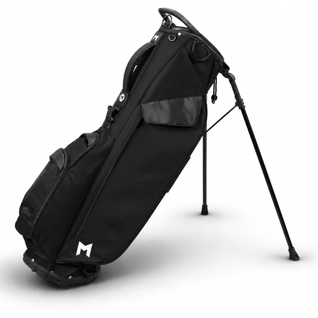 A black stand golf bag with a white stylized 'M' logo near the bottom, displayed on a clean white background.