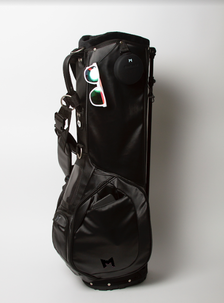 The black MV2 golf bag is made from microsuede and has multiple magnetic closure pockets. 