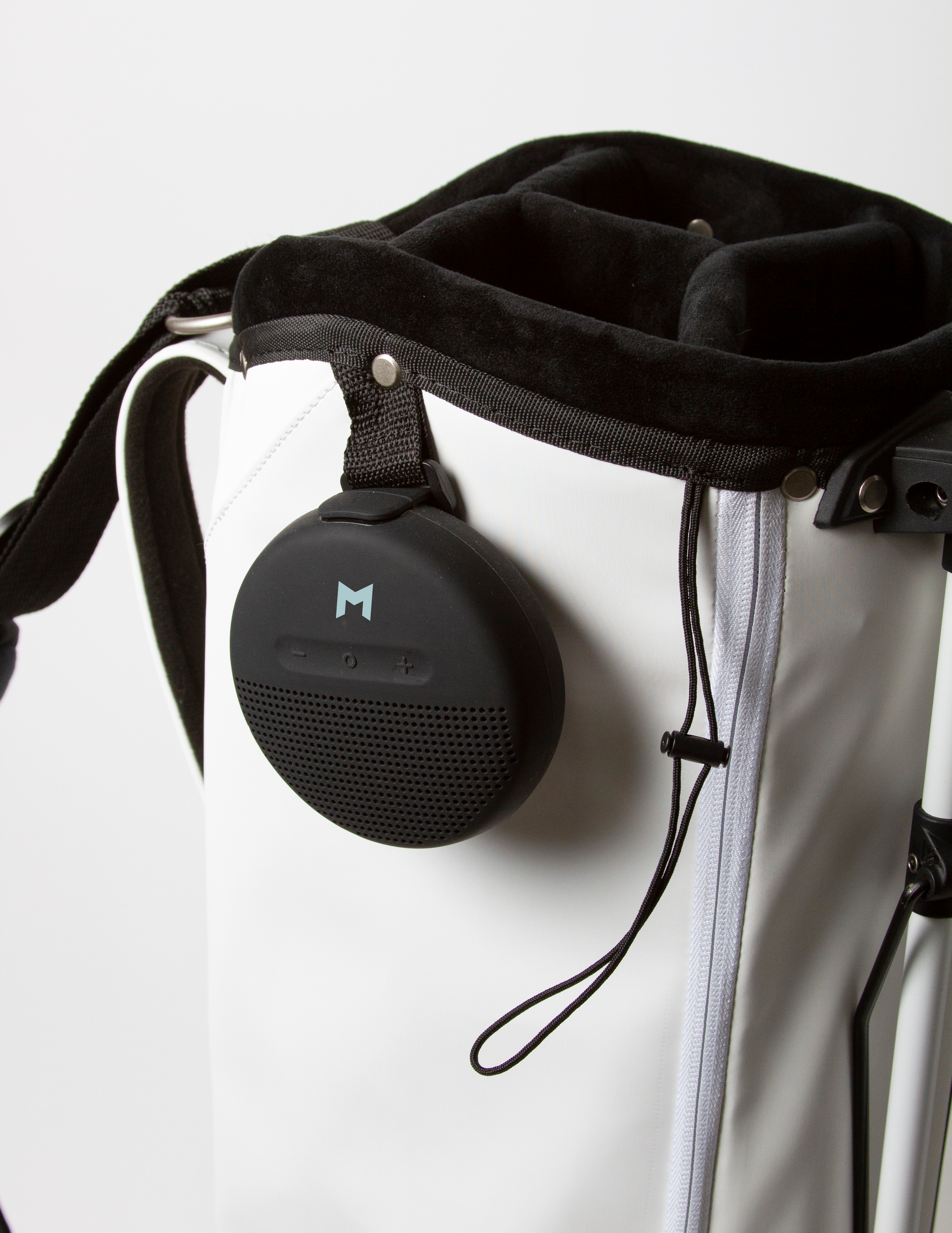 White MNML GOLF bag made from microsuede, featuring a waterproof bluetooth speaker.