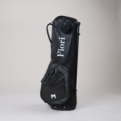The MNML GOLF x Fiori golf collaboration features a white, contrasting, hand-painted Fiori golf logo on MNML GOLF's black MV2 golf bag.