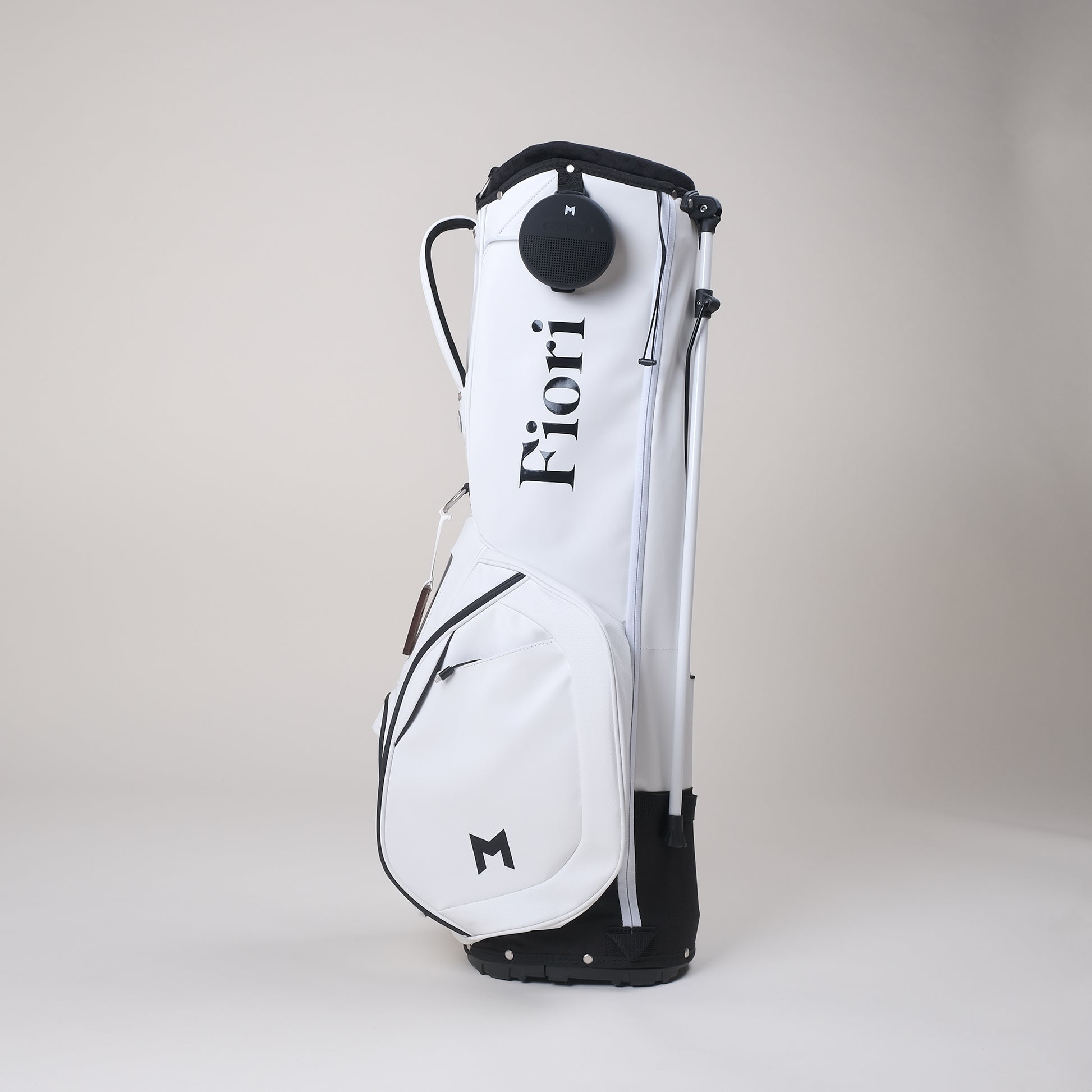 The MNML GOLF and Fiori Golf collaboration features a white MV2 golf bag with a contrasting black Fiori Golf logo. 