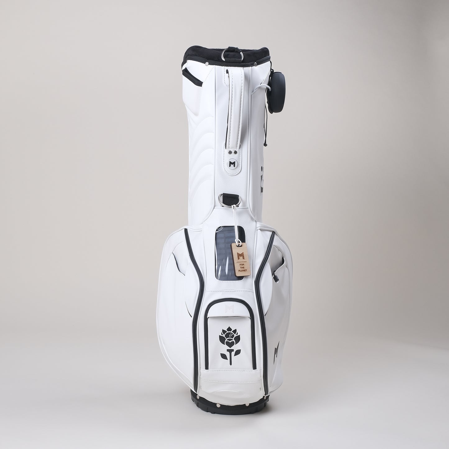 White MNML GOLF bag with black Fiori Golf flower logo painted on magnetic ball pocket. 